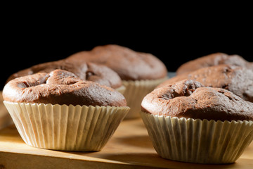 Closeup chocolate muffin on wooden board