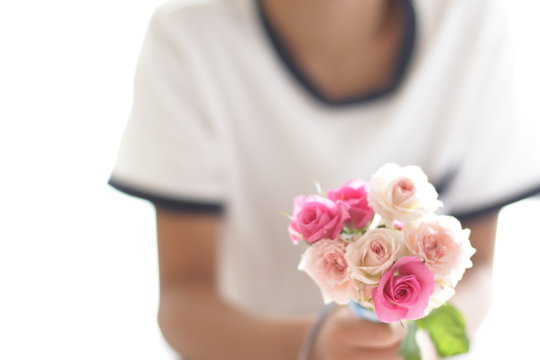 Boy holds a bouquet for Mother's day image