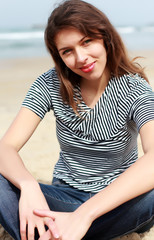 Fototapeta na wymiar Beautiful girl on the winter beach