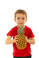 Kid boy holding big pineapple