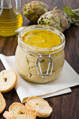 Artichoke pesto in glass jar.