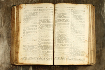 Obraz premium Open old Bible on wooden background
