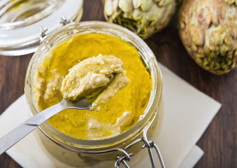 Artichoke pesto in glass jar.