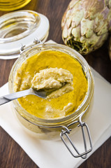 Artichoke pesto in glass jar.