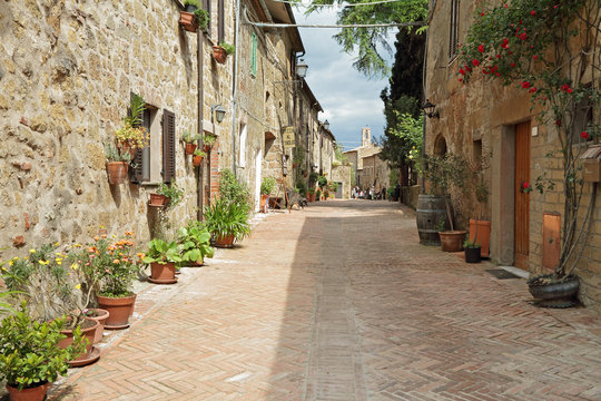 Fototapeta street paved with brick in old italian borgo Sovana in Tuscany,