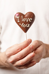man with chocolate heart in the hands