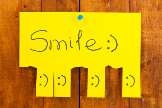 Color advertisement smile on wooden background