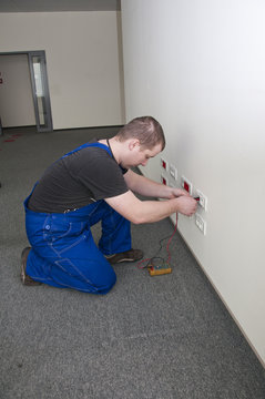 employee does measure the electrical socket