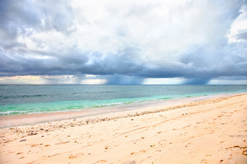 Fototapeta na wymiar Dramatic sunset cloudy sky on sand beach