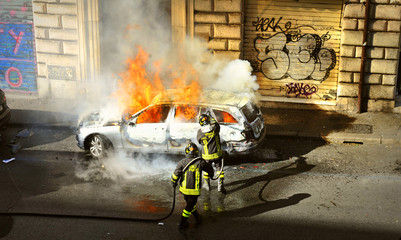 Naklejka premium Riots - Fire fighters respond to a car fire