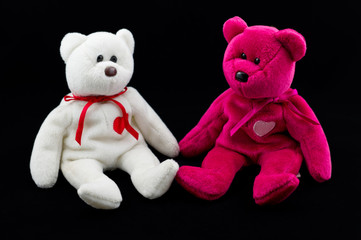 Shot of two teddy bear's on black background