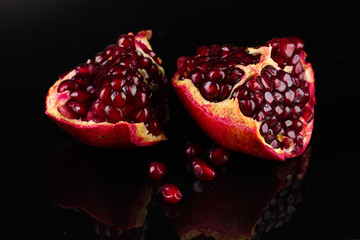 ripe pomegranate fruit on black background