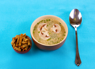 Tasty soup on blue tablecloth