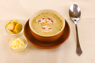 Tasty soup on beige tablecloth