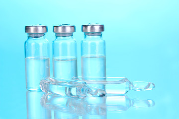 Medical ampoules on blue background