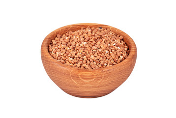 Buckwheat in a wooden bowl, isolated on white background