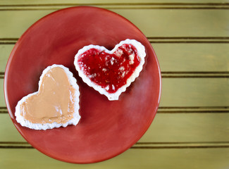 Fototapeta na wymiar Heart shape peanut butter and jelly sandwtich