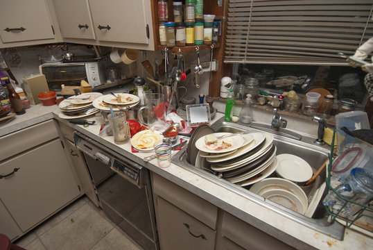 Dirty dishes piled up in sink after a party