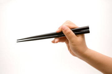 Hand Holding Closed Chopsticks