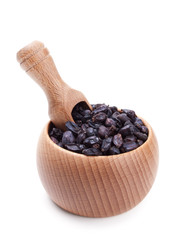 Wooden scoop in bowl full of dry barberry