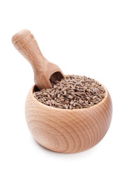 Wooden scoop in bowl full of dill seeds