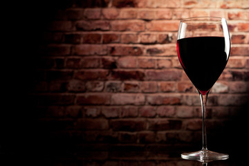 glass of wine on the background of a brick wall