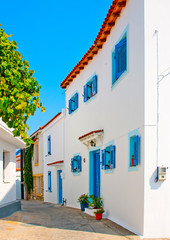 Old house with blue doors  and windows in Skiathos Greece