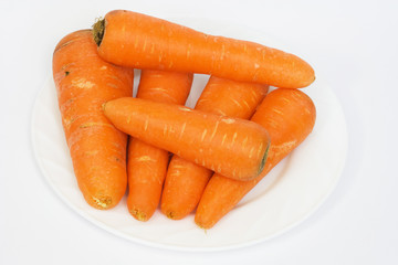 Ripe fresh carrots on a white background.
