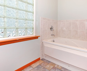 New bathroom corner with glass block window and tub.