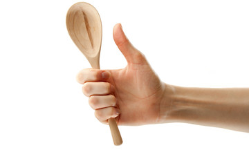 Wooden spoon in female hand