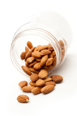 Almonds in the plastic jar on white