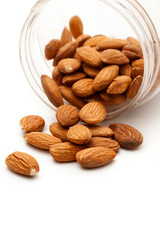 Almonds in the plastic jar on white