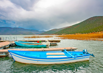 Naklejka na ściany i meble Old wooden fishing boats in the lake Prespa in Greece.
