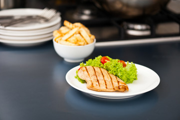 Chicken, French fries and salad