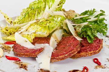 Salad from fried sausages, lettuce with sour cream sauce