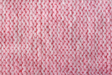 Pink color wool knitted background closeup