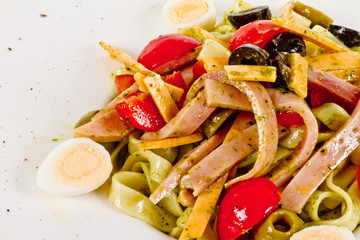photo of delicious pasta (tagliatele) with bacon and tomatoes