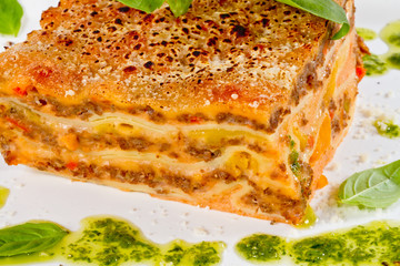 Closeup of lasagna and basil fork