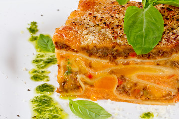 Closeup of lasagna and basil fork