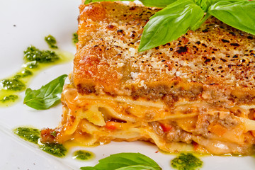 Closeup of lasagna and basil fork
