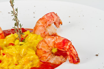 Plate of Shrimps Risotto garnished with fresh parsley and Parmes