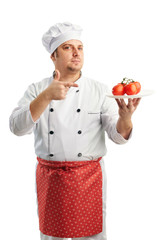 attractive chef in uniform with tomatoes