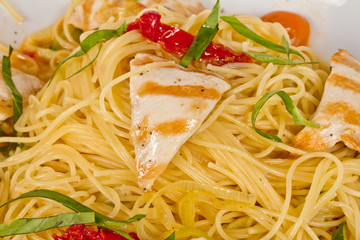close-up of plate of pasta and chicken