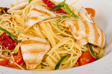 close-up of plate of pasta and chicken