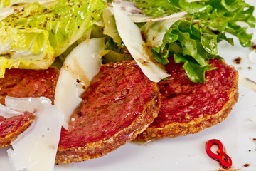 Salad from fried sausages, lettuce with sour cream sauce