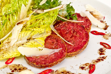 Salad from fried sausages, lettuce with sour cream sauce