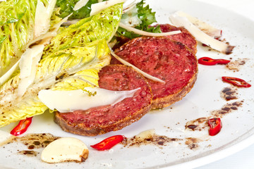 Salad from fried sausages, lettuce with sour cream sauce