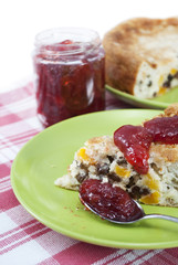 Rice pudding with raisins and dried apricots with strawberry jam