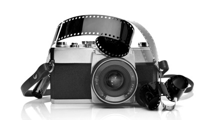 Old 35mm film photo camera on white background with 35mm film st