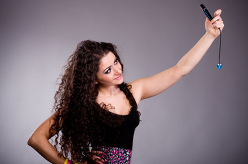 Beautiful young woman in dress on dark background.